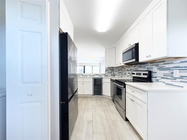 The kitchen comes equipped with stainless steel appliances. - 2029 N Ocean Blvd