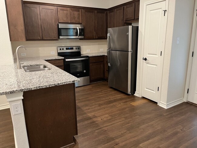Building Photo - Move Fast! Gated Townhome Near Lackland AFB with Private Yard & EV-Ready Garage