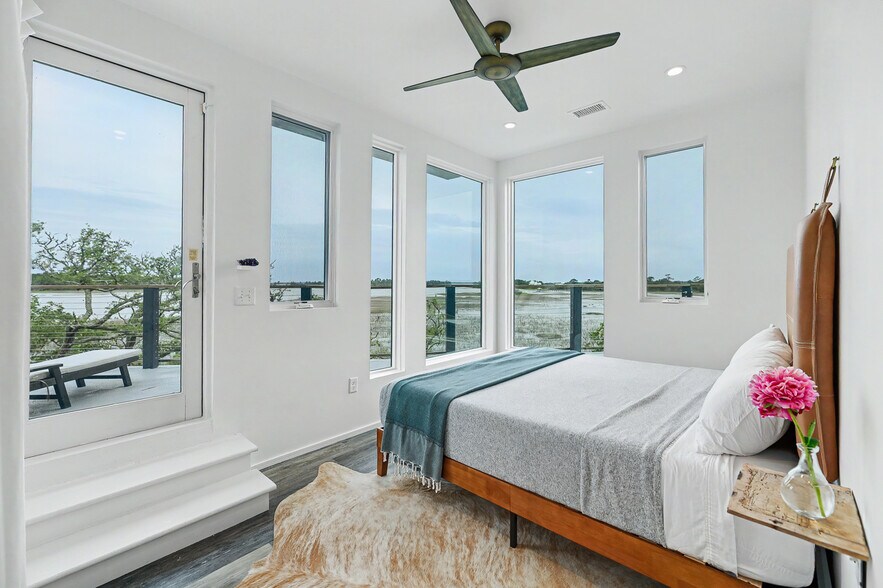 Primary bedroom with queen bed and direct access to rooftop patio - 2179 Sol Legare Rd