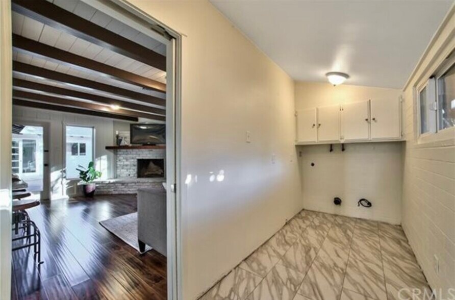 Convenient indoor laundry room with storage, located off the flex room. - 332 E Deodar St