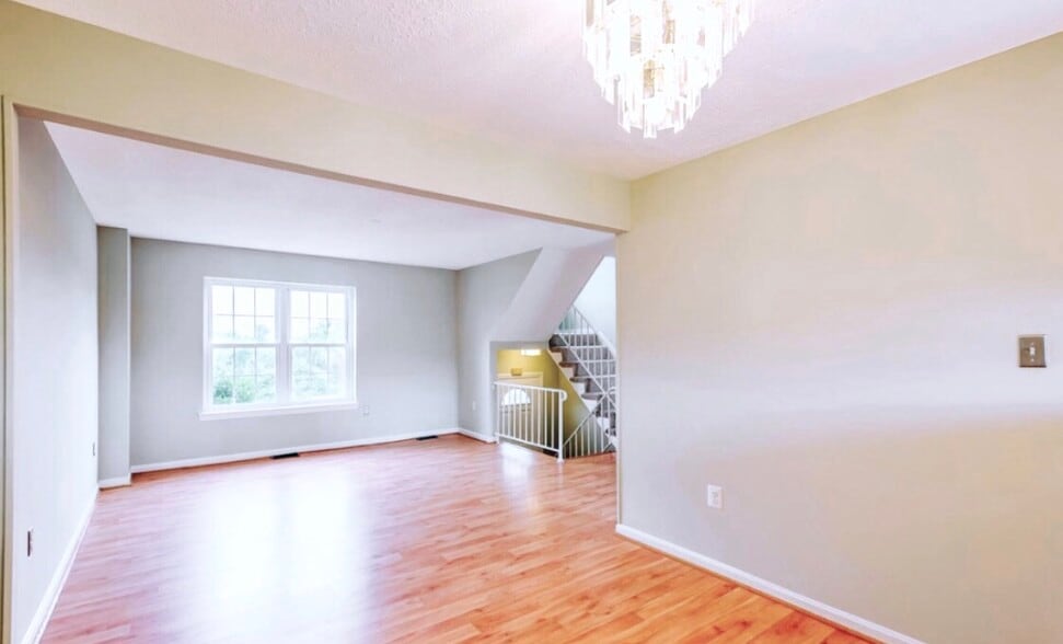 Another view of the living space, the entrance, stairs to the upstairs bedrooms. - 4767 Kandel Ct