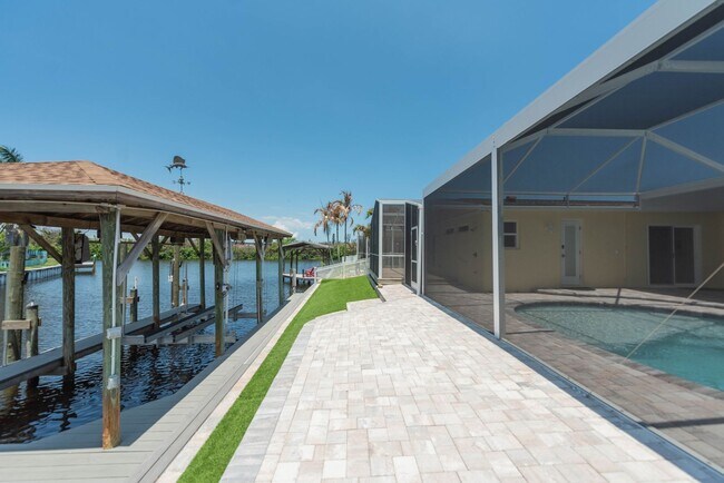 Building Photo - Live the ultimate Space Coast waterfront lifestyle at this stunning beachside canal home in Satel...