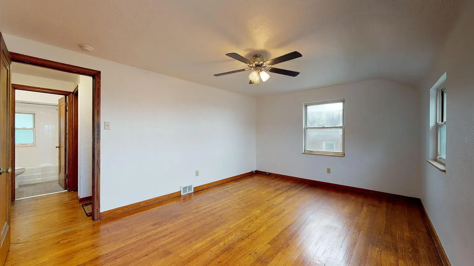 Spacious Bedroom #1 with refinished original hardwood flooring - 31 Marylea Ave