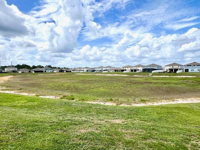 Building Photo - Open concept home offering four bedrooms, three baths, a two car garage and open lanai.