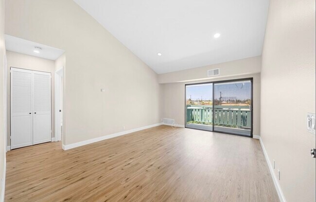 Living room, balcony & hidden laundry - 20415 S Vermont Ave