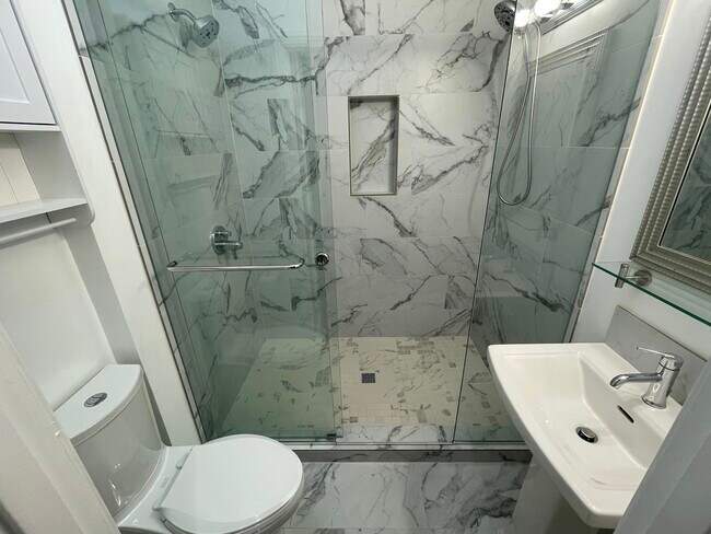 Bathroom with two shower heads and tile. - 1817 SW Cable Ave