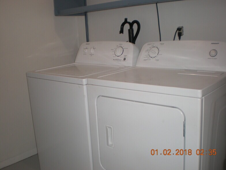 Washer and dryer in laundry room. Extra shelves for storage. - 1160 Clinton St