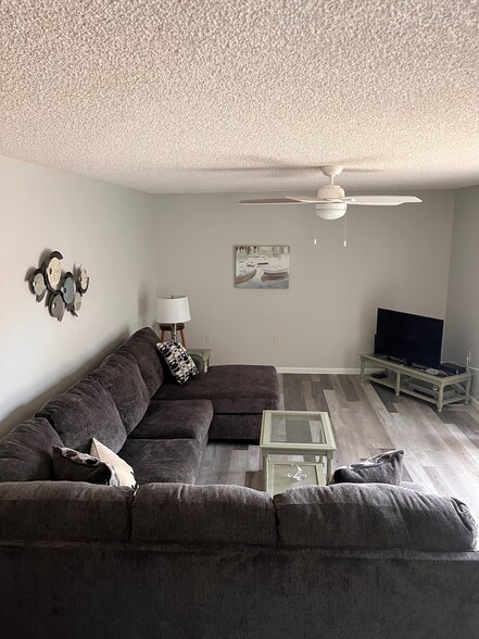 living room- new flooring and couch - 5830 SE Windsong Ln