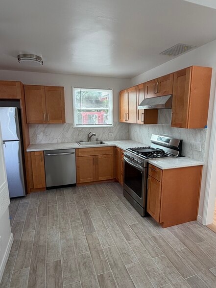new tiled floor with stone countertop - 701 Indiana Ave