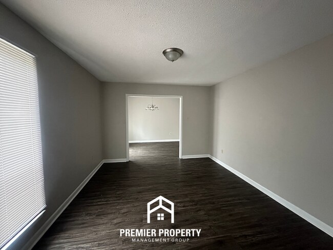 Building Photo - Charming 3BR Memphis Home | Rustic Brick Fireplace, Formal Dining & Fenced Backyard