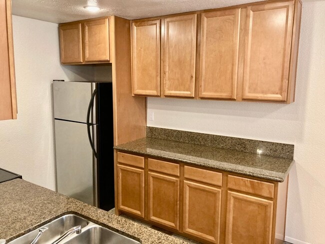 Building Photo - One Bedroom with Garage and IN-Unit laundry in Resort-Style Complex