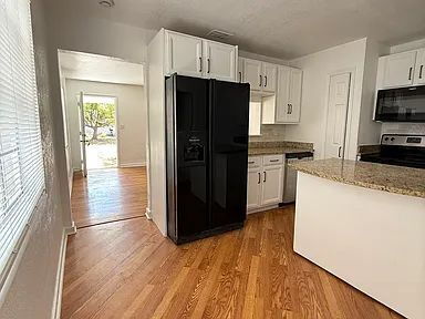 Building Photo - Charming Centrally Located Home | Wood Floors + Fenced Yard