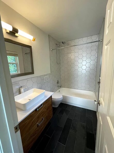 Full bath attached to the second bedroom. European style wall mounted vanity and toilet. - 1641 N Washington St
