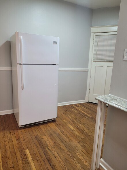 Rear door to access the stairs to the back of the property and basement. - 2055 Alfred Ave