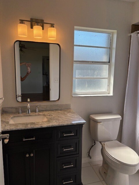 bathroom has newer vanity with granite and large tiled shower. - 2321 SE 5th Ct