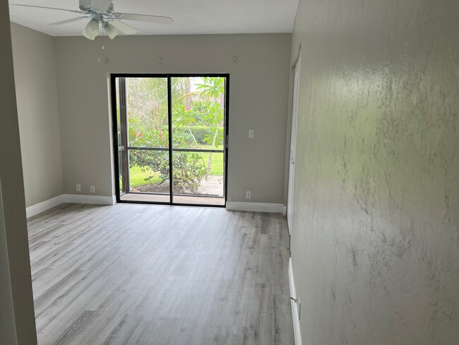 Master Bedroom with view of lanai and gardens - 1733 Courtyard Way