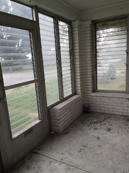 enclosed front porch door and windows with slats that open and close - 2305 7th Street Rd