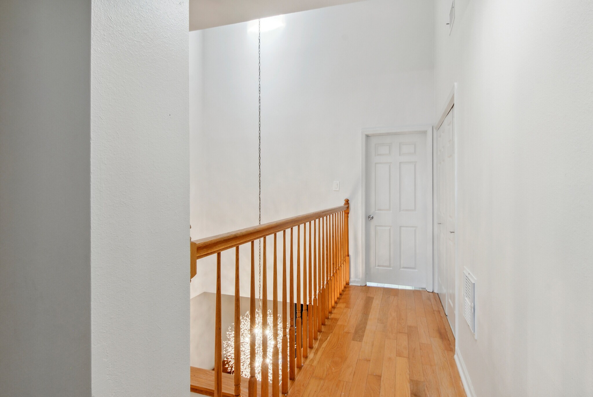 Upstairs hallway between Master Bedroom and Front Bedroom. The balcony overlooks the Dining Room. - 4502 Park Dr N