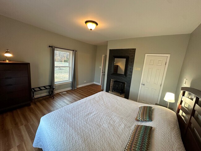 Electric stove and chest of drawers in king bedroom - 4804 Friends School Rd