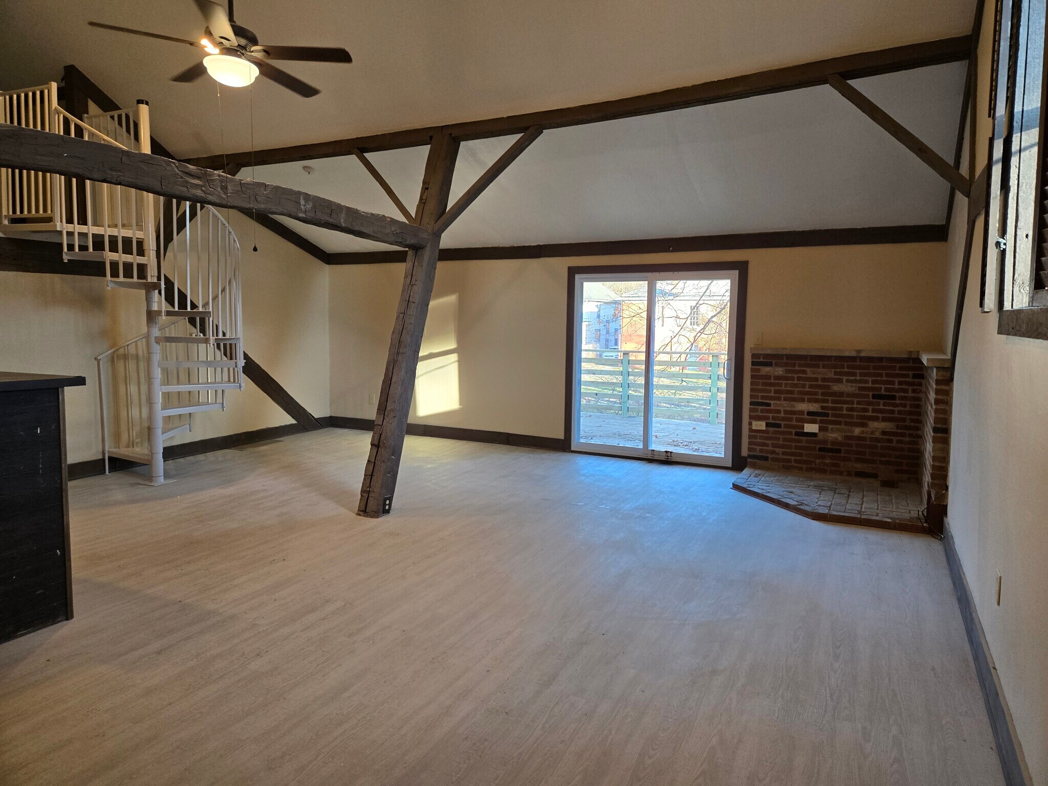 Open living area with brickwork and large windows. - 60 W Winter St