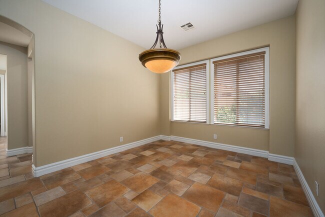 Separate dining area off the living room and steps from the wet bar with wine refrigerator. - 2850 Bronzino Ct