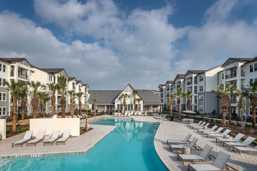 Enjoy the serene poolside experience at this luxury apartment complex, perfect for relaxation and leisure. - Livano Kemah
