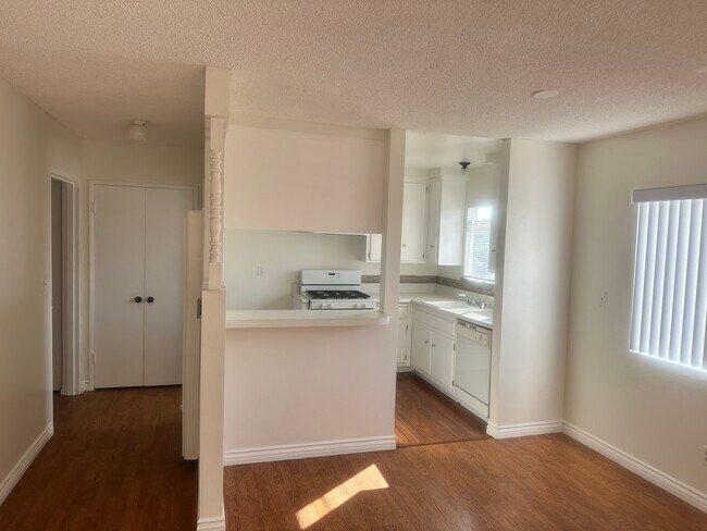 Dinning Area lookin into Kitchen and Hallway with Pantry Double Doors - 327 Culver Blvd
