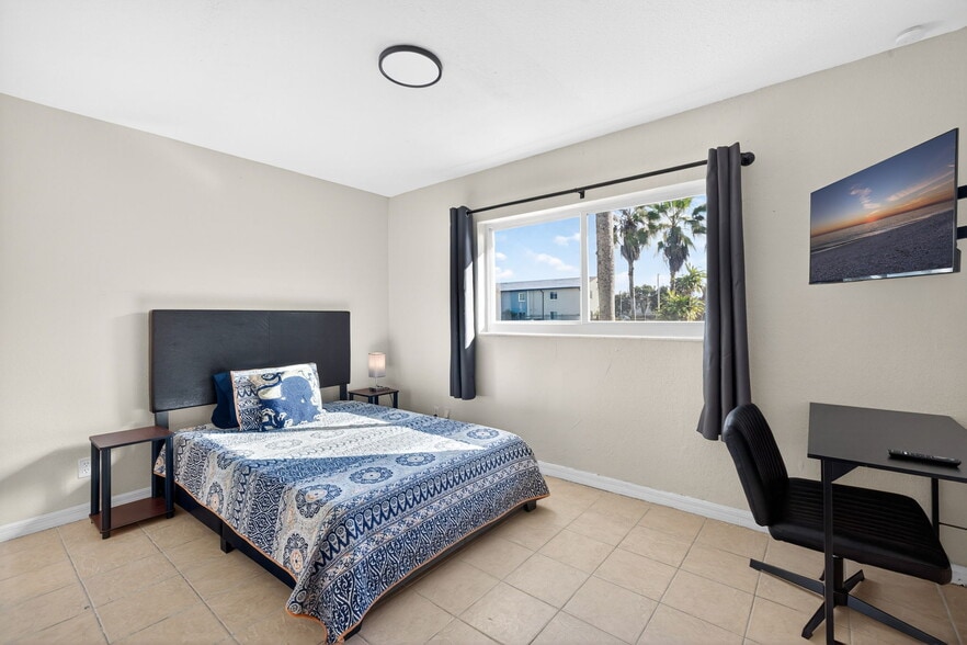 Furnished bedroom with Wall Mounted TV Desk & chair - 1778 Aquarius Ct