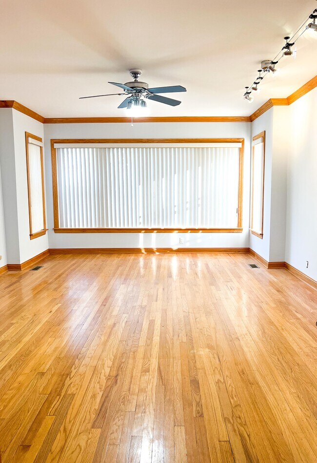 Living room with hardwood floor - 6042 W Miami Ave