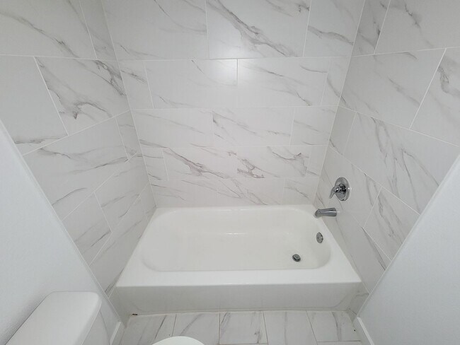 Building Photo - This newly constructed 3-bedroom, 2-bathroom unit offers modern living with 1,150 sq ft of space....