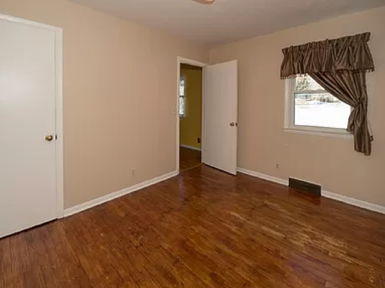 Bedroom, off kitchen, north side of home/window faces backyard; currently beige walls - 8120 Burdette St