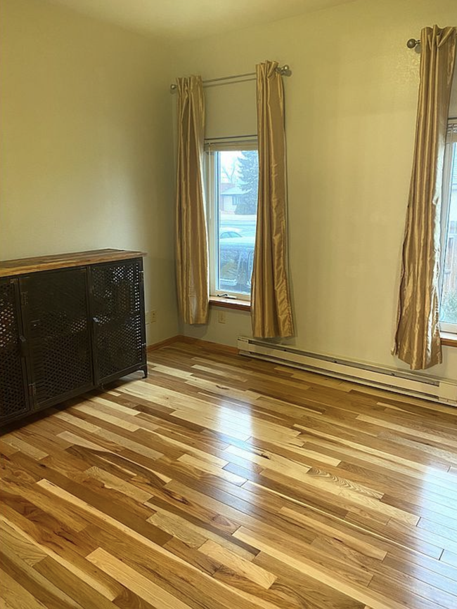 Main level bedroom with hardwood floors. - 711 S 11th St