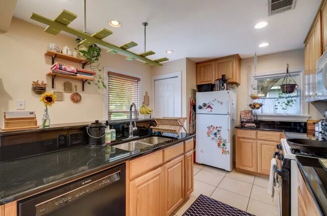 Building Photo - Discover Your Austin Oasis: Revitalized Bungalow with Hardwood Floors and Entertainer's Deck!