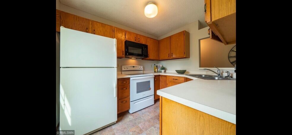 Kitchen, cabinets have been refinished, microwave replaced - 10918 Quebec Ave S