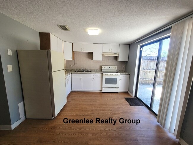 Building Photo - Cozy 2 Bed/1 Bath Duplex Apt with a Carport and Large Fenced Back Yard!