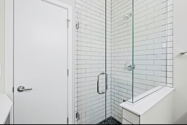 Step into a luxurious, contemporary shower space with pristine design. - Harley House