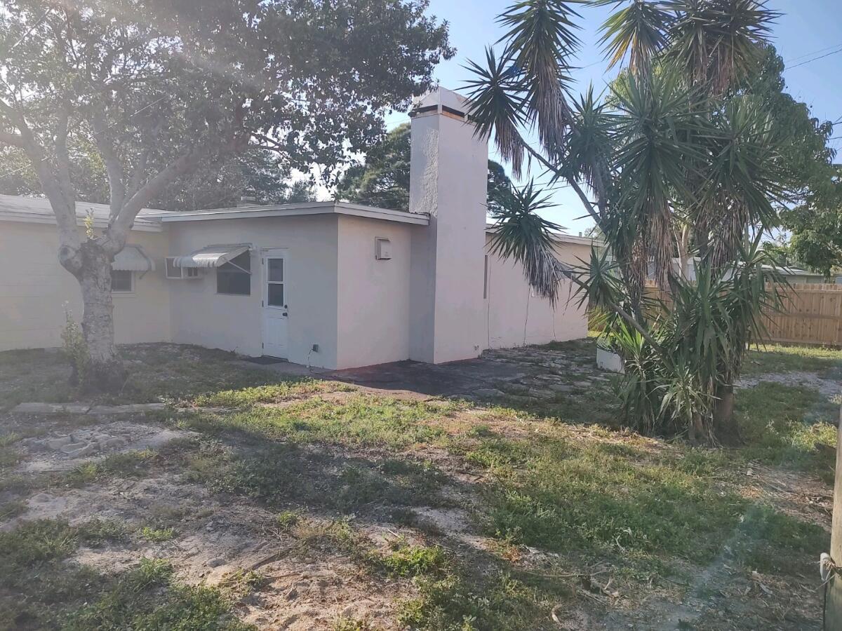 Partially fenced backyard looking at the house - 6449 101st Way N