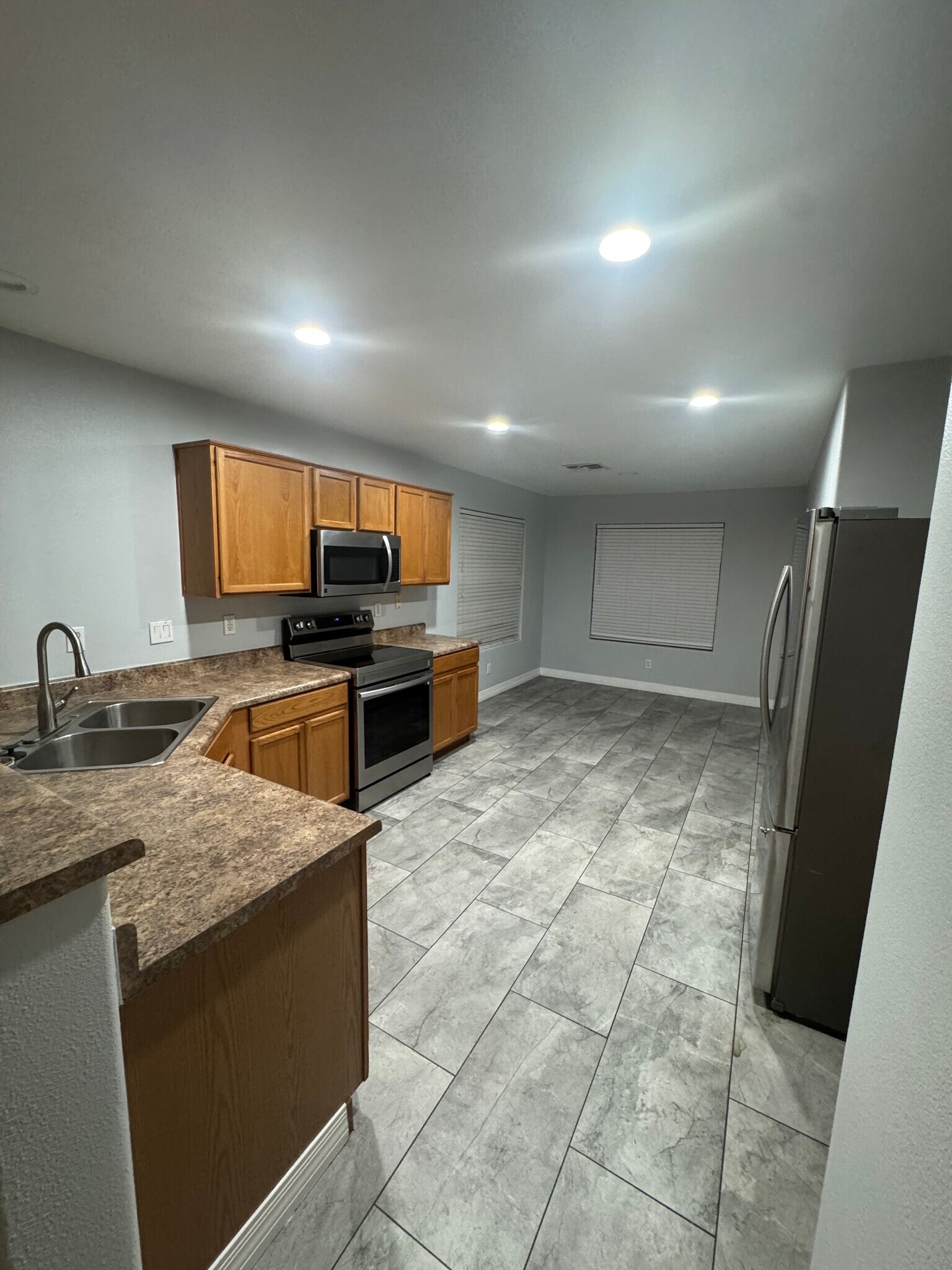 Kitchen with stove, microwave, dishwasher - 10791 W Roanoke Ave