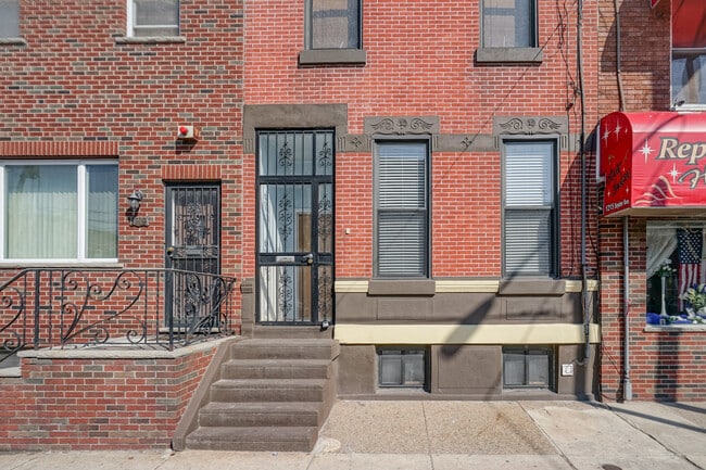 Building has a security gate on the front entrance. - 1217 Snyder Ave