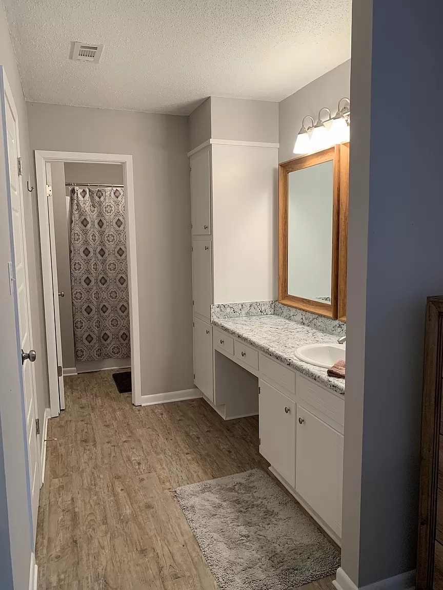 Master bathroom with two large framed mirrors, lots of counter space, linen closet, bath and shower - 113 Penny Ln