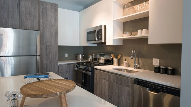 Two tone cabinetry with ample storage options including pantry - Modera Medford