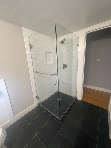 newly tiled shower surround and glass enclosure - 568 Merrimac St