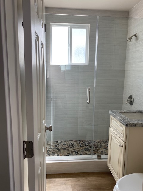 Remodeled bathroom with custom tile and rock floor shower. - 210 30th St