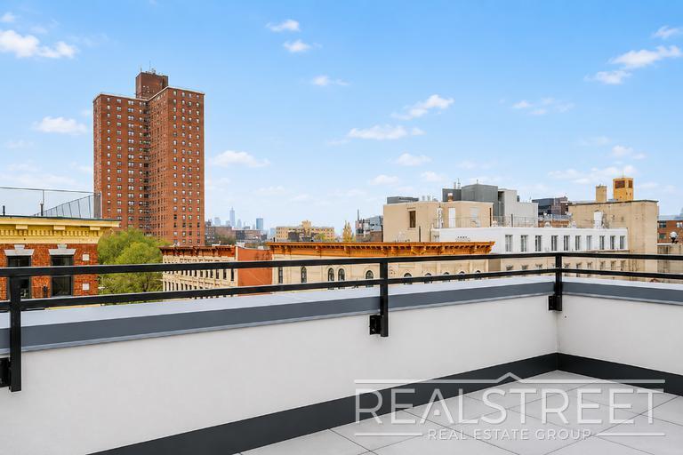 Building Photo - Sun-Filled Penthouse Duplex with Massive Private Terrace & Bonus Storage Room