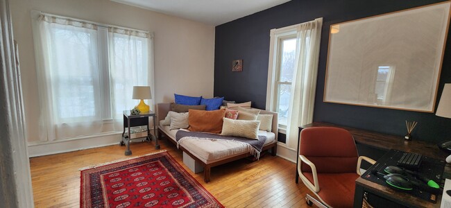 Large sunny bedroom with three windows. - 1023 28th Ave NE