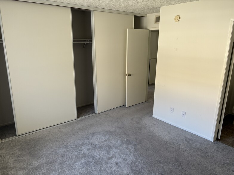 Master bedroom with full closet wall and organization - 18071 Beneda Ln