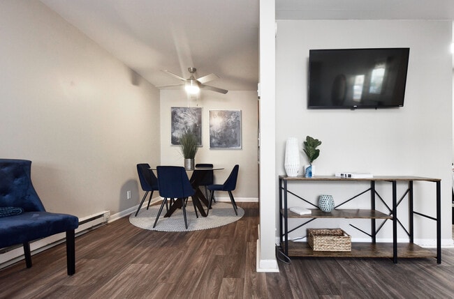 Explore a chic and inviting dining and living area, featuring contemporary decor and seamless design. - Oaks at Old Hickory