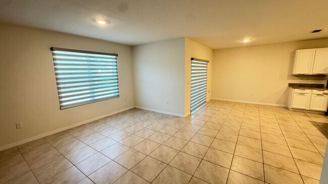 Building Photo - Available NOW! Spacious 4BD/2BA Haven in Villages at Harmony – Your Dream Home Awaits! WASHER & D...