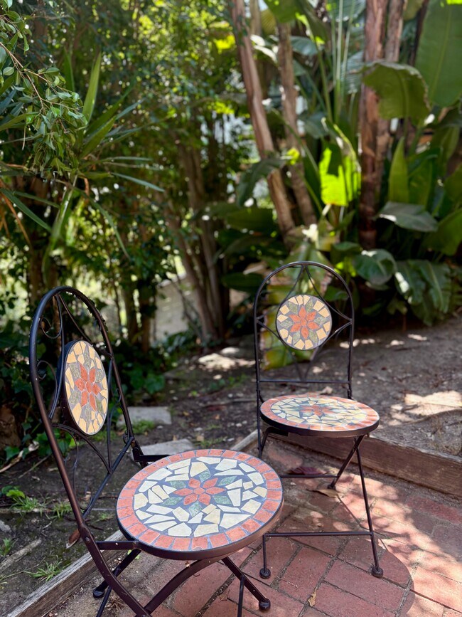 Charming mosaic wrought-iron café table for another peaceful spot to relax. - 1672 Rotary Dr