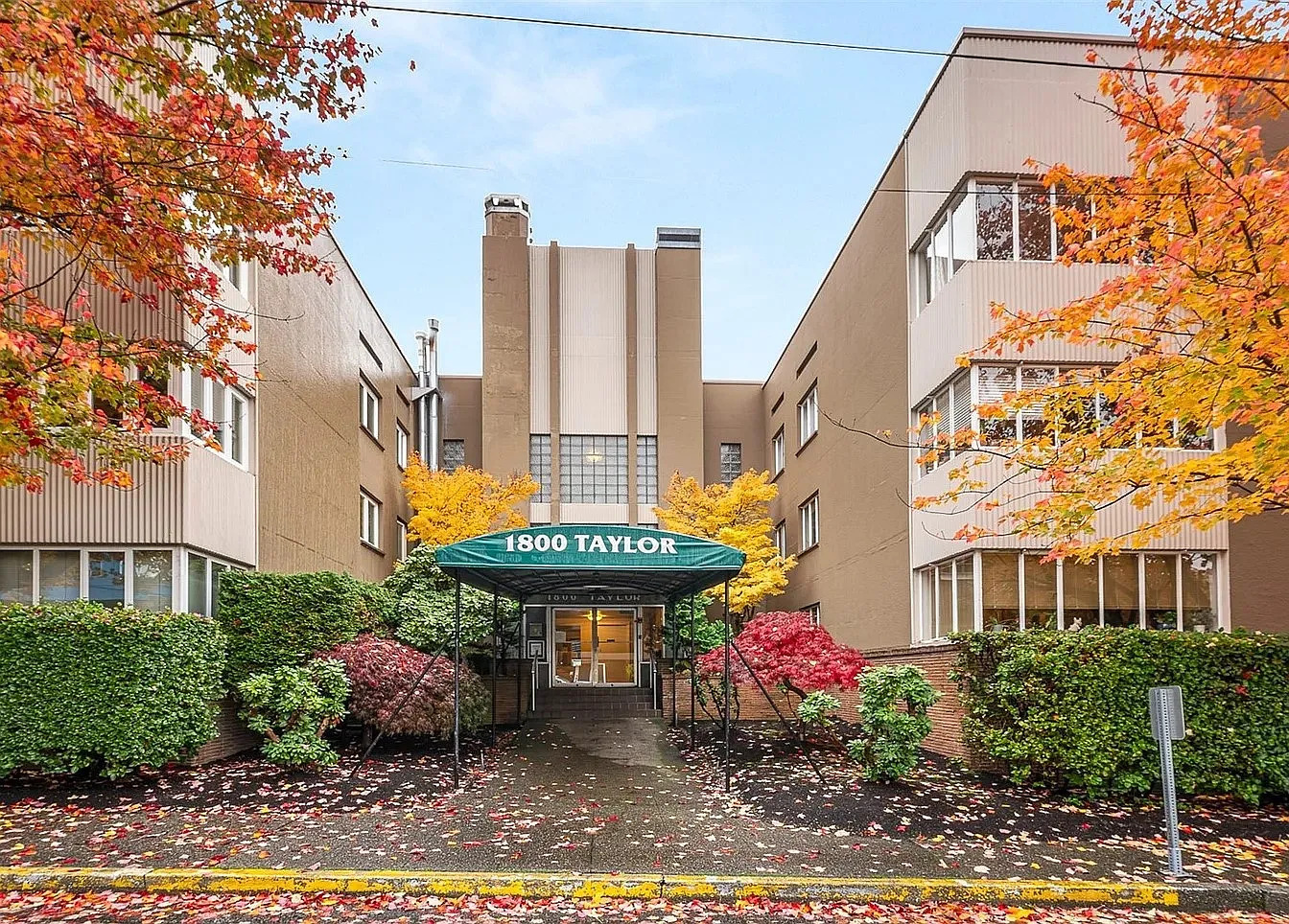 Front entrance. Trees outside windows don't block light, but have beautiful changing leaves. - 1800 Taylor Ave N